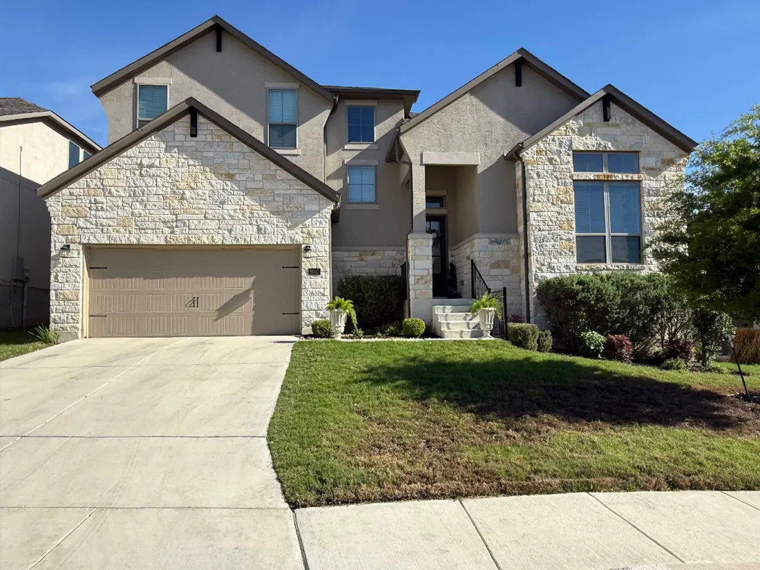 Seamless gutters on a two-story stone home in the San Antonio area