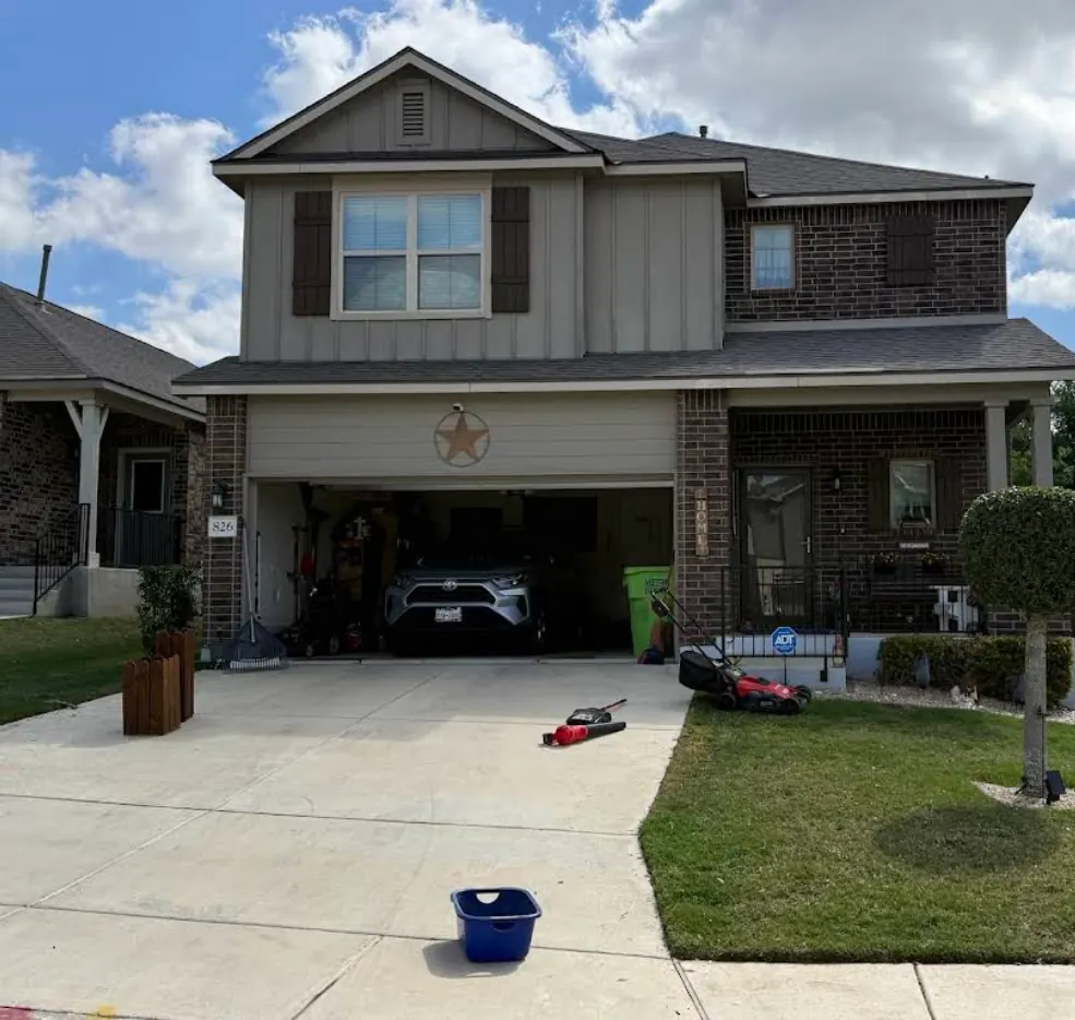 Gutter installation underway at a two-story Texas home