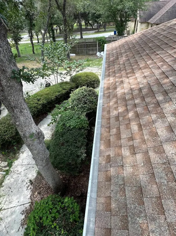 Micro-mesh gutter guard fitted over a seamless gutter run