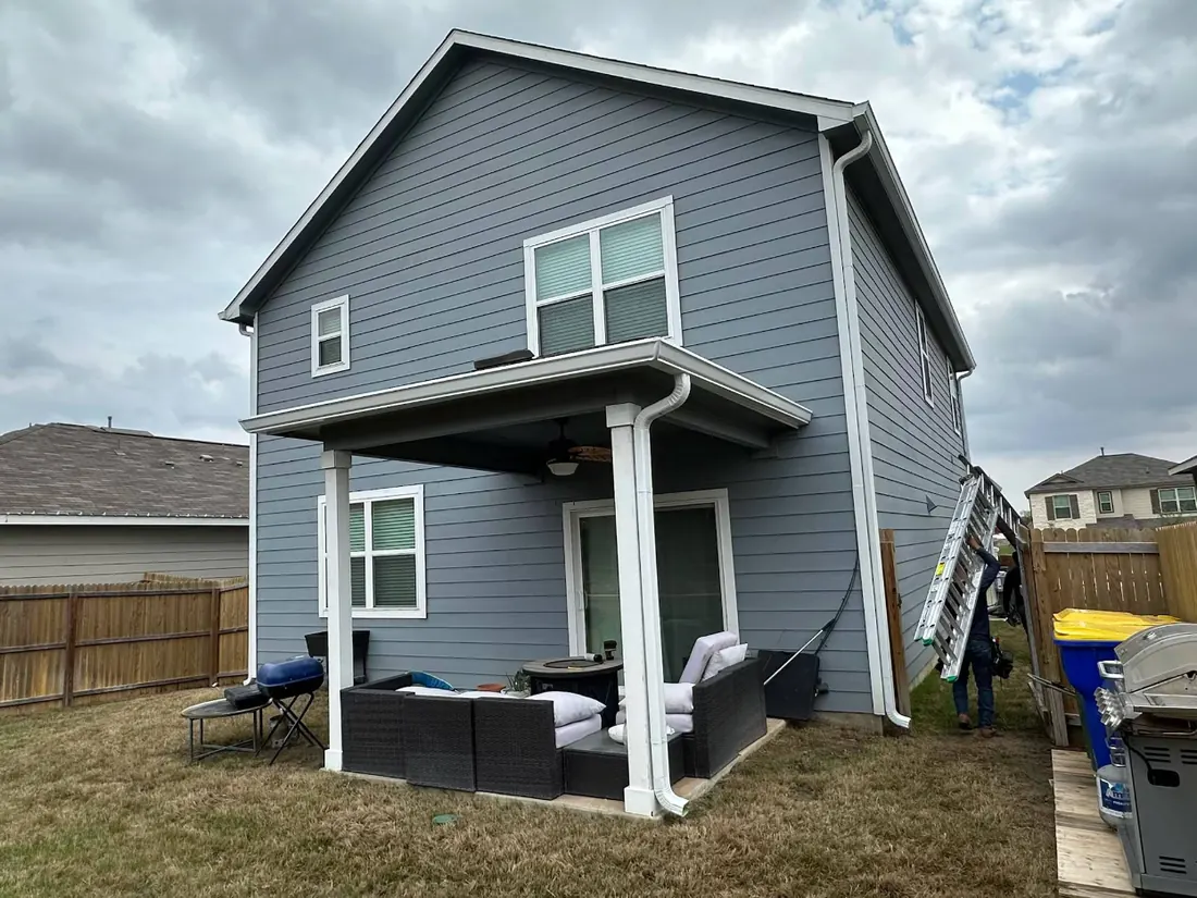 Seamless gutters on a two-story home with a covered patio