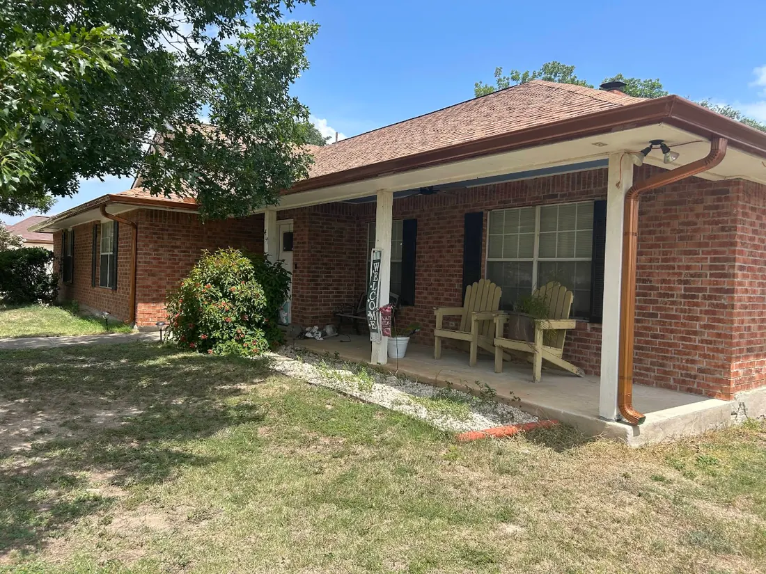 Seamless gutters and downspout on a red brick ranch home