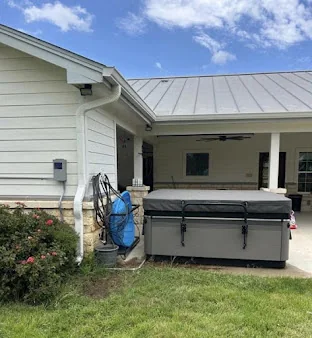 Seamless gutters on a white home with a standing seam metal roof