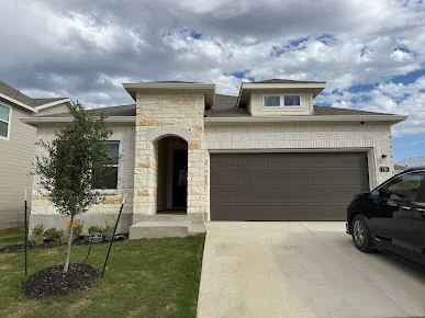 Seamless gutters and downspout on a new stone and stucco home