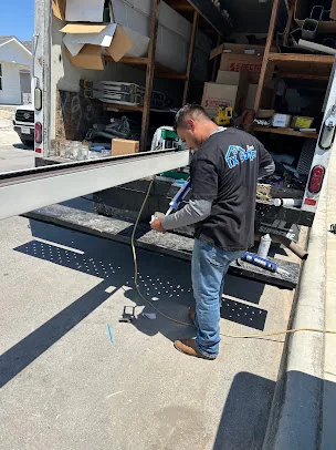 TX Gutter Expert forming seamless gutter on-site at the truck