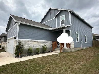 Seamless gutters on a blue two-story home