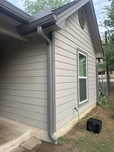 Gutter and downspout detail on a light-sided home
