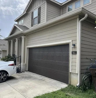 Seamless gutters on a two-story home above the garage