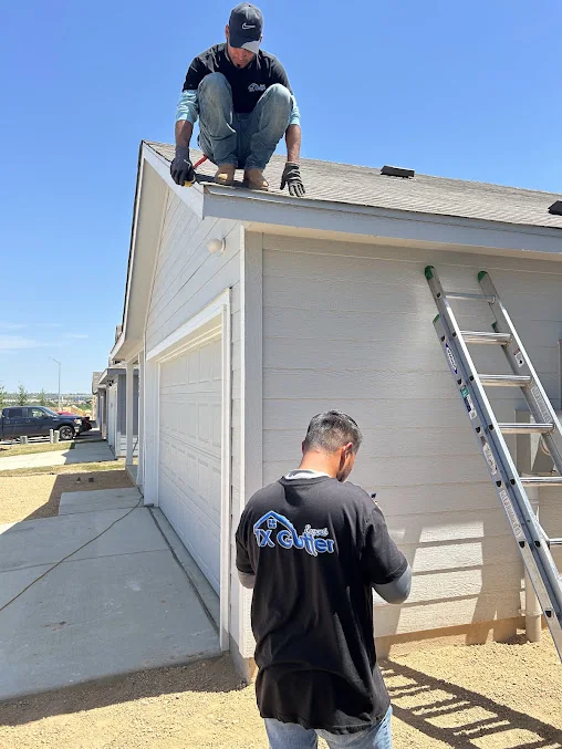 TX Gutter Expert crew setting a gutter run from the roof