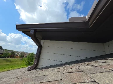 Seamless gutter above a garage door